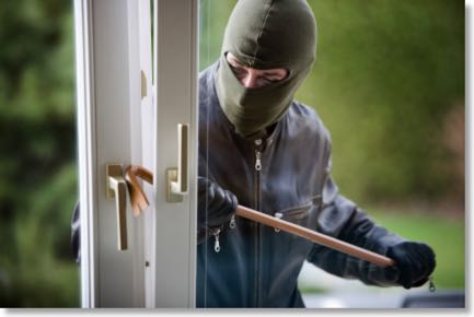 Burglar breaking into a house of the crowbar